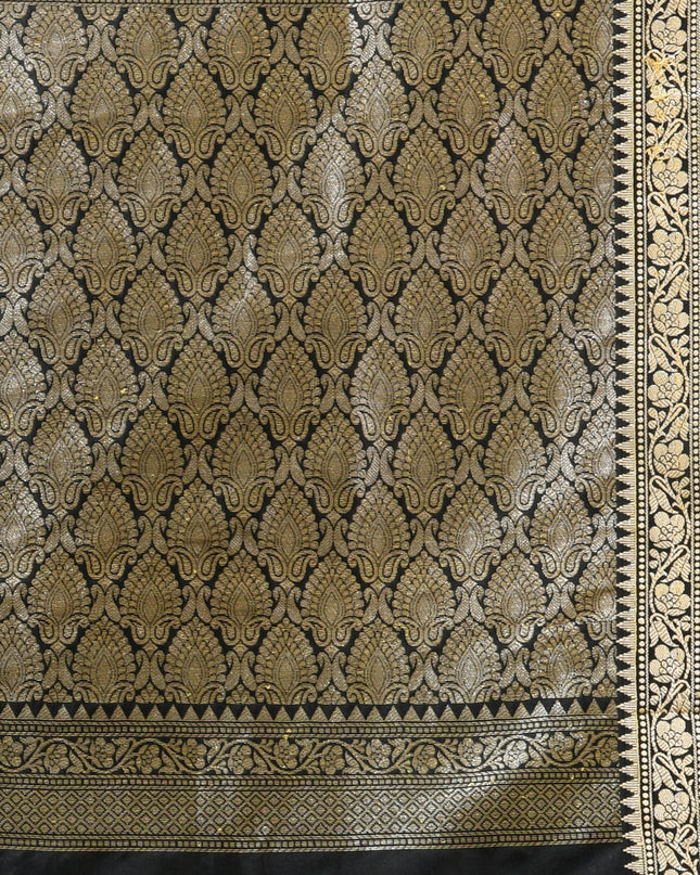 Close-up of silver zari butti on black pure silk saree pallu.