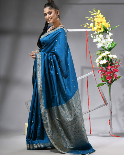 Close-up of silver zari butti on blue pure silk saree.