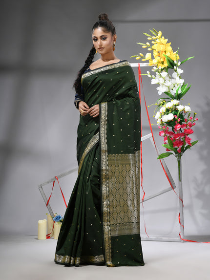 DESH BIDESH Dark Green Kanjivaram silk blend saree with silver zari butti.