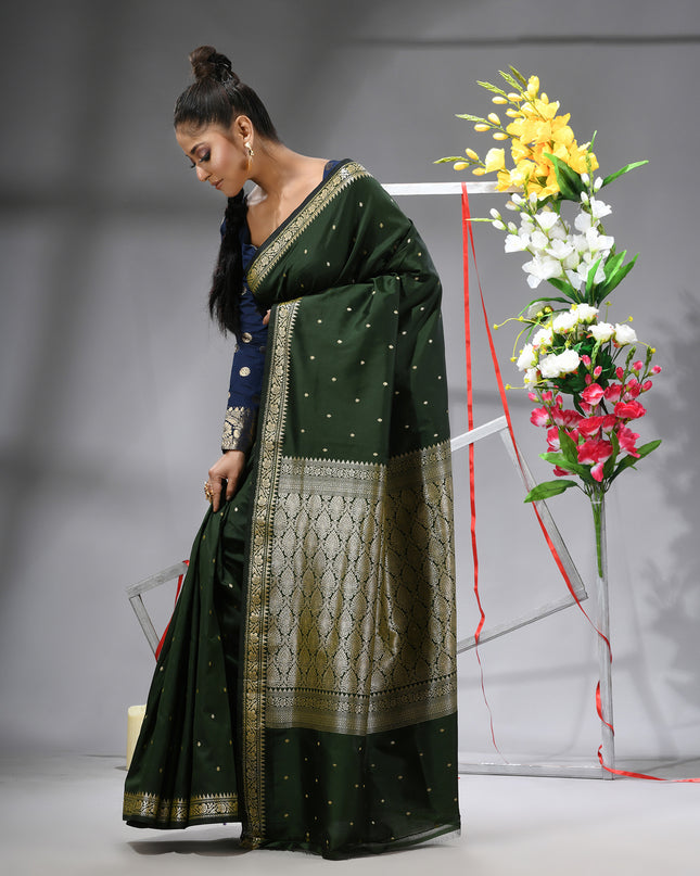 Model showcasing dark green Banarasi Kanjivaram wedding saree.