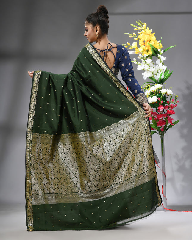 Back view of a graceful, dark green Kanjivaram silk saree.