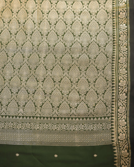 Soft silk dark green saree with rich jacquard patterns for festive occasions.
