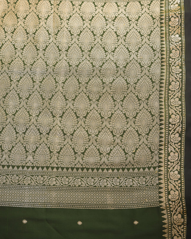 Soft silk dark green saree with rich jacquard patterns for festive occasions.
