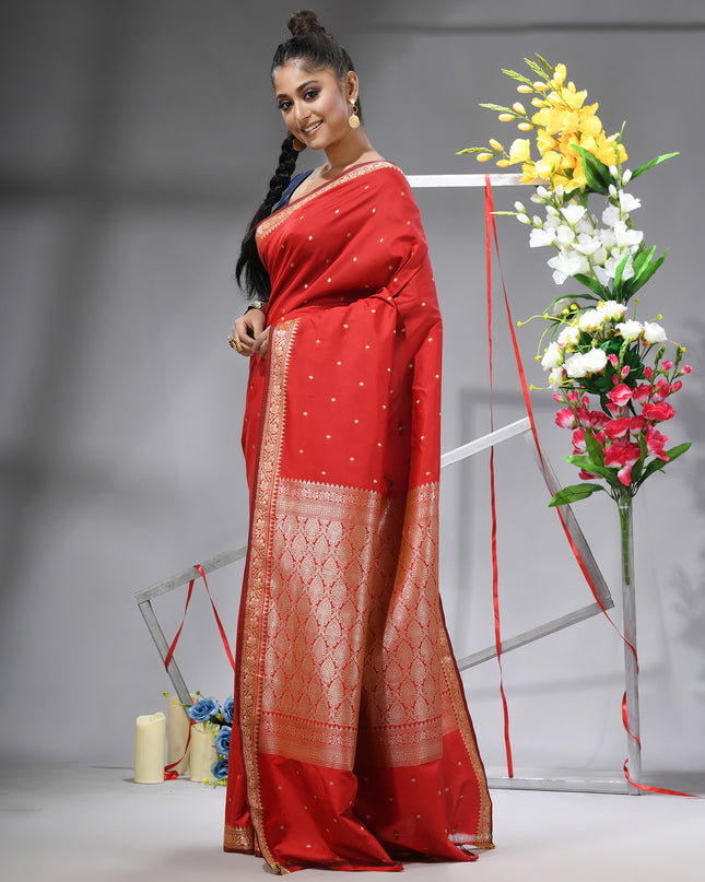 Red silk blend saree with traditional woven silver zari border.