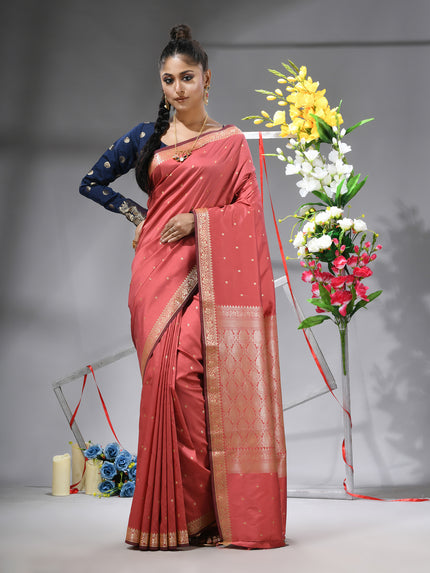 DESH BIDESH Salmon Kanjivaram silk blend saree with silver zari butti.
