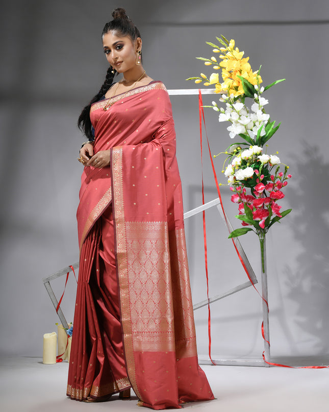 Model showcasing salmon Banarasi Kanjivaram wedding saree.