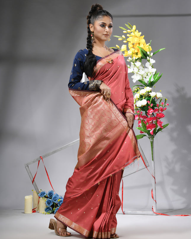 Salmon silk blend saree with traditional woven silver zari border.