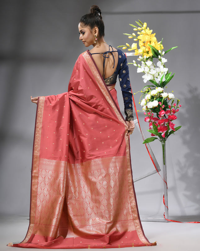 Luxurious salmon Kanjivaram saree with matching blouse piece back view.