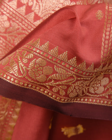 Bridal salmon silk saree with intricate silver zari butti work fabric details
