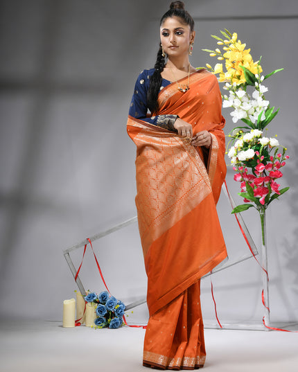 Model showcasing orange Banarasi Kanjivaram wedding saree.