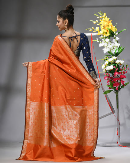 Back view of a graceful orange Kanjivaram silk saree.