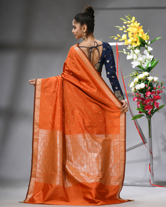 Back view of a graceful orange Kanjivaram silk saree.