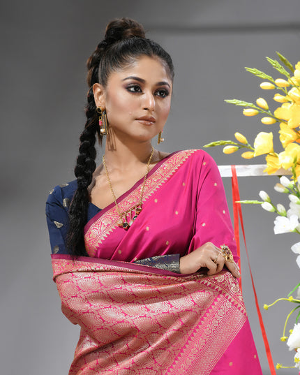 Close-up of silver zari butti on pink pure silk saree.