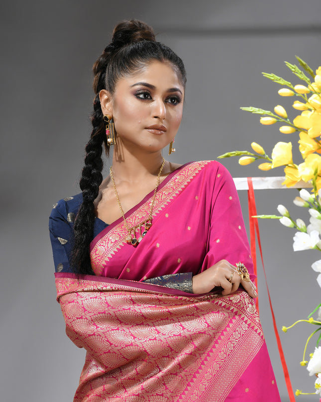 Close-up of silver zari butti on pink pure silk saree.