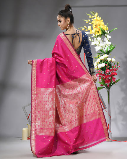 Model showcasing pink Banarasi Kanjivaram wedding saree back view.
